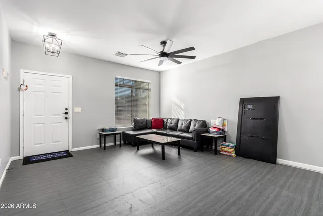 a living room with furniture and a chandelier