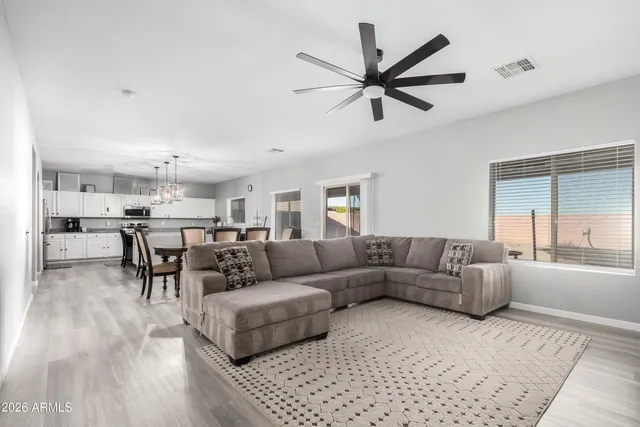 a living room with furniture and a view of kitchen