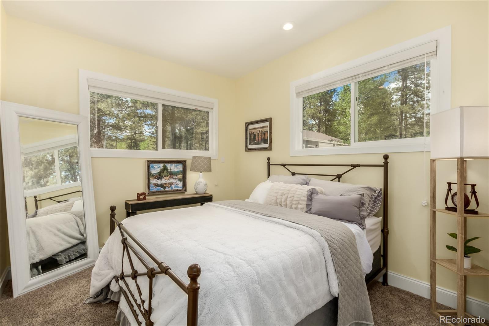 95 Double Tree Road Bailey, CO 80421 - Photo 12 of 40 a bedroom with a bed and a large window