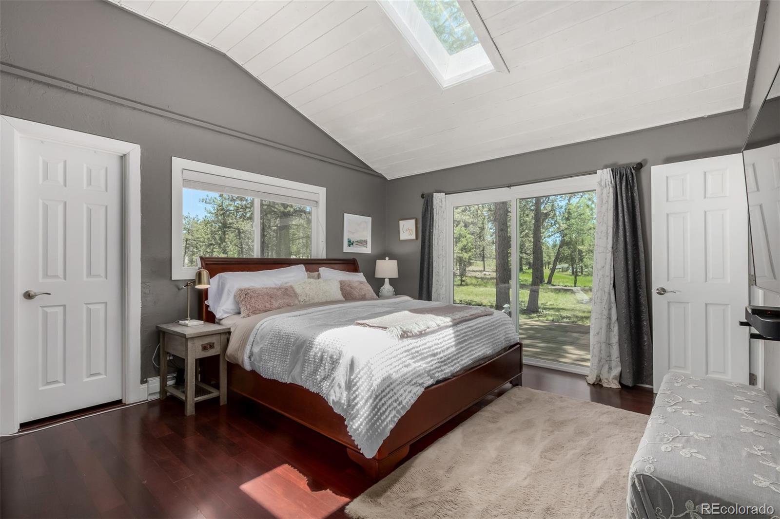 95 Double Tree Road Bailey, CO 80421 - Photo 16 of 40 a bedroom with a bed and a large window