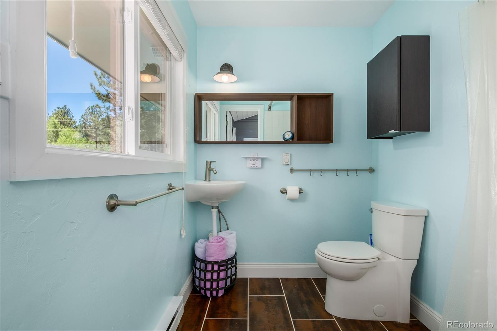 95 Double Tree Road Bailey, CO 80421 - Photo 18 of 40 a bathroom with a toilet sink and mirror