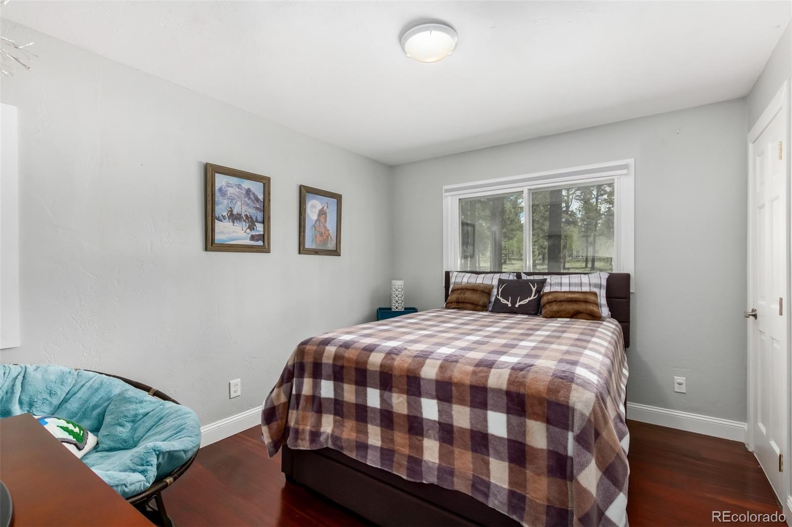 95 Double Tree Road Bailey, CO 80421 - Photo 20 of 40 a bedroom with a bed and glass window