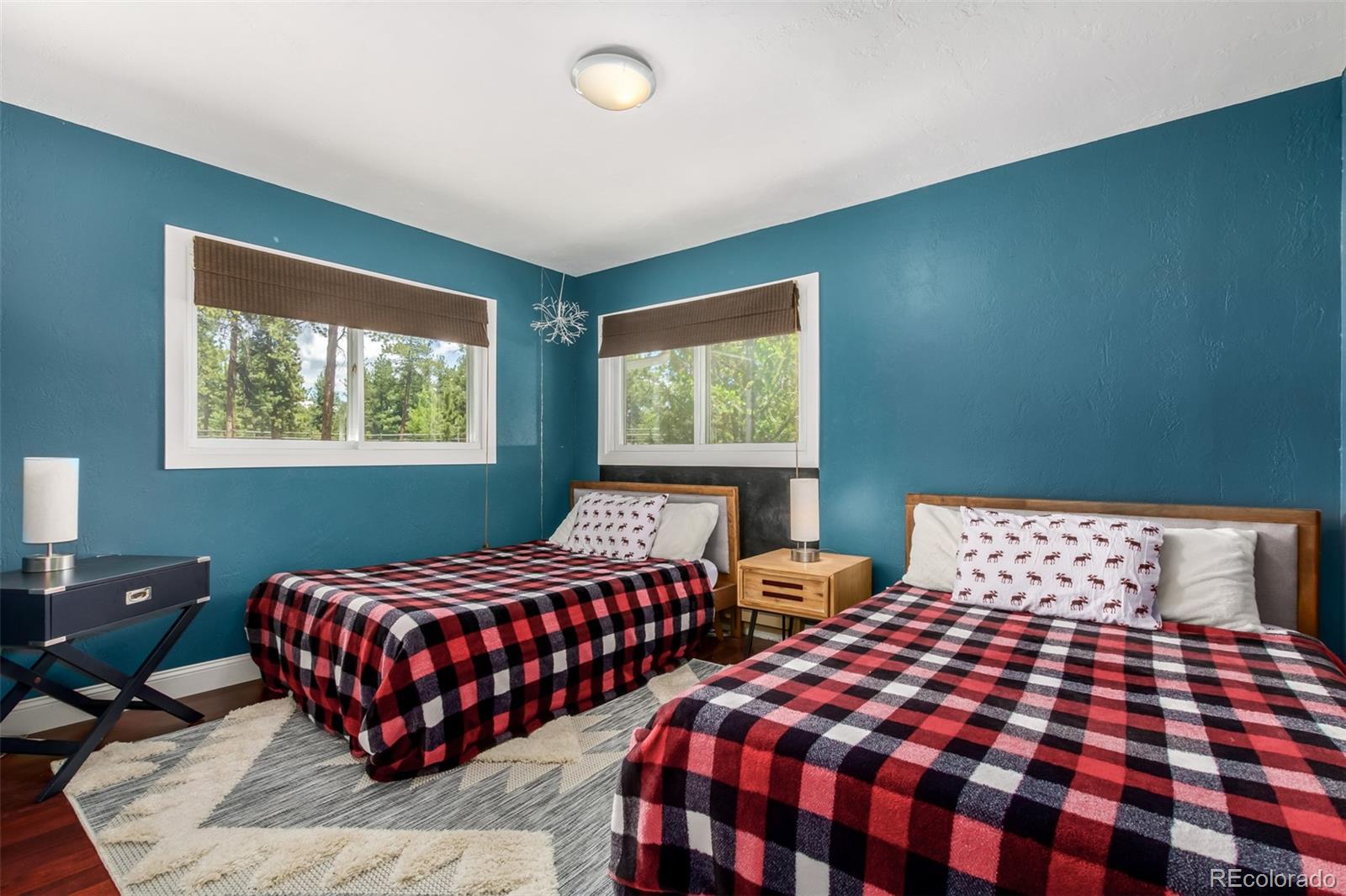 95 Double Tree Road Bailey, CO 80421 - Photo 21 of 40 a bedroom with two beds and a lamp