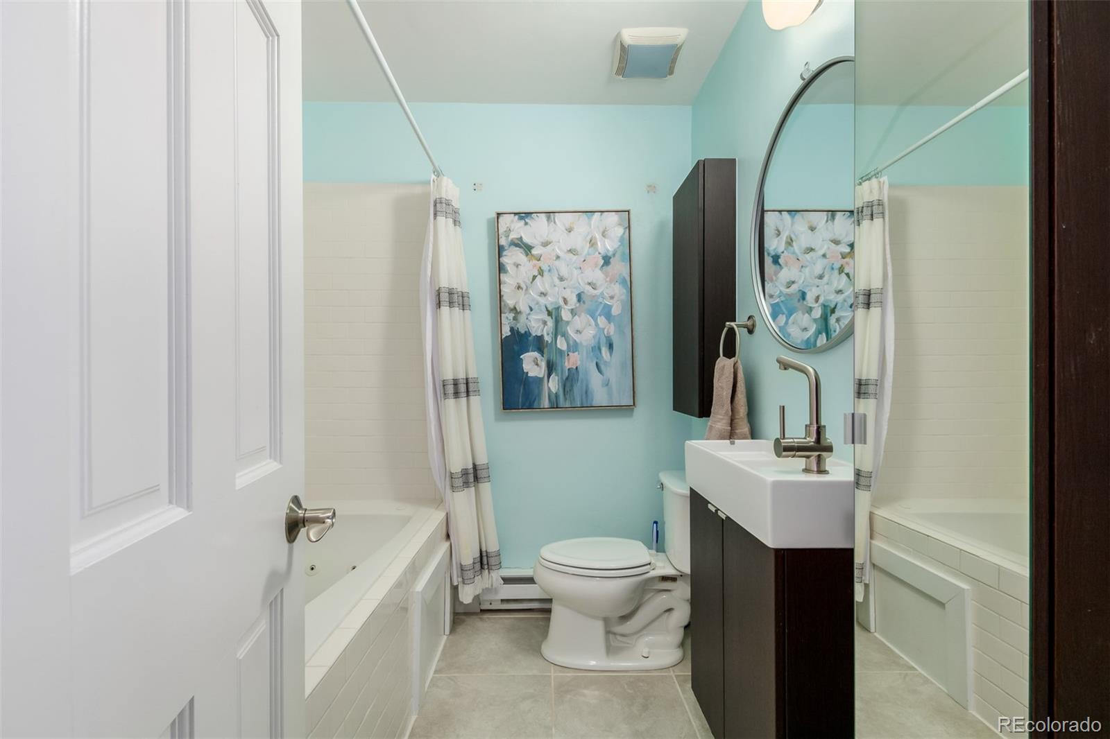 95 Double Tree Road Bailey, CO 80421 - Photo 22 of 40 a bathroom with a sink a toilet and shower curtain