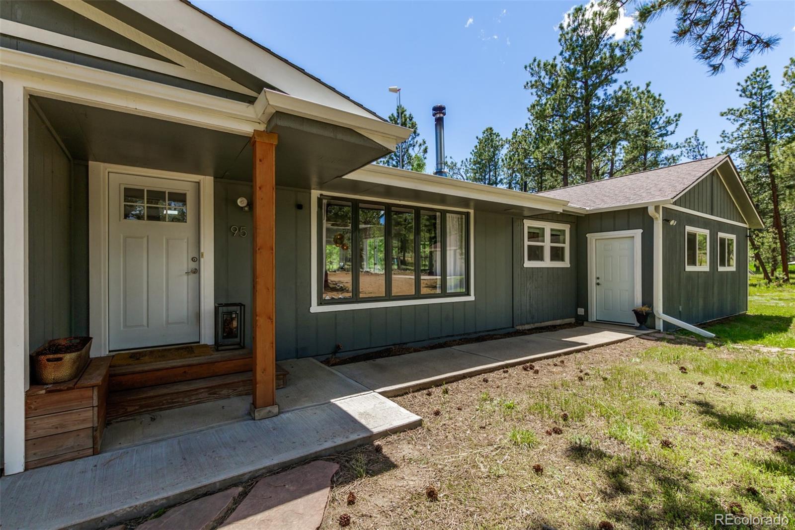 95 Double Tree Road Bailey, CO 80421 - Photo 23 of 40 a front view of a house with a yard