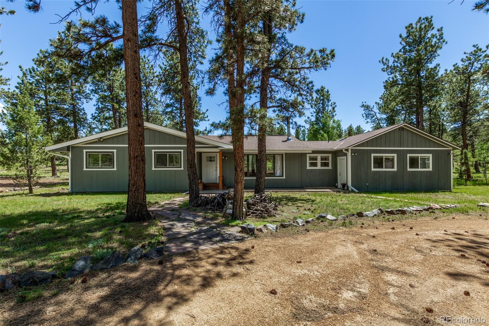 95 Double Tree Road Bailey, CO 80421 - Photo 25 of 40 a front view of a house with a garden