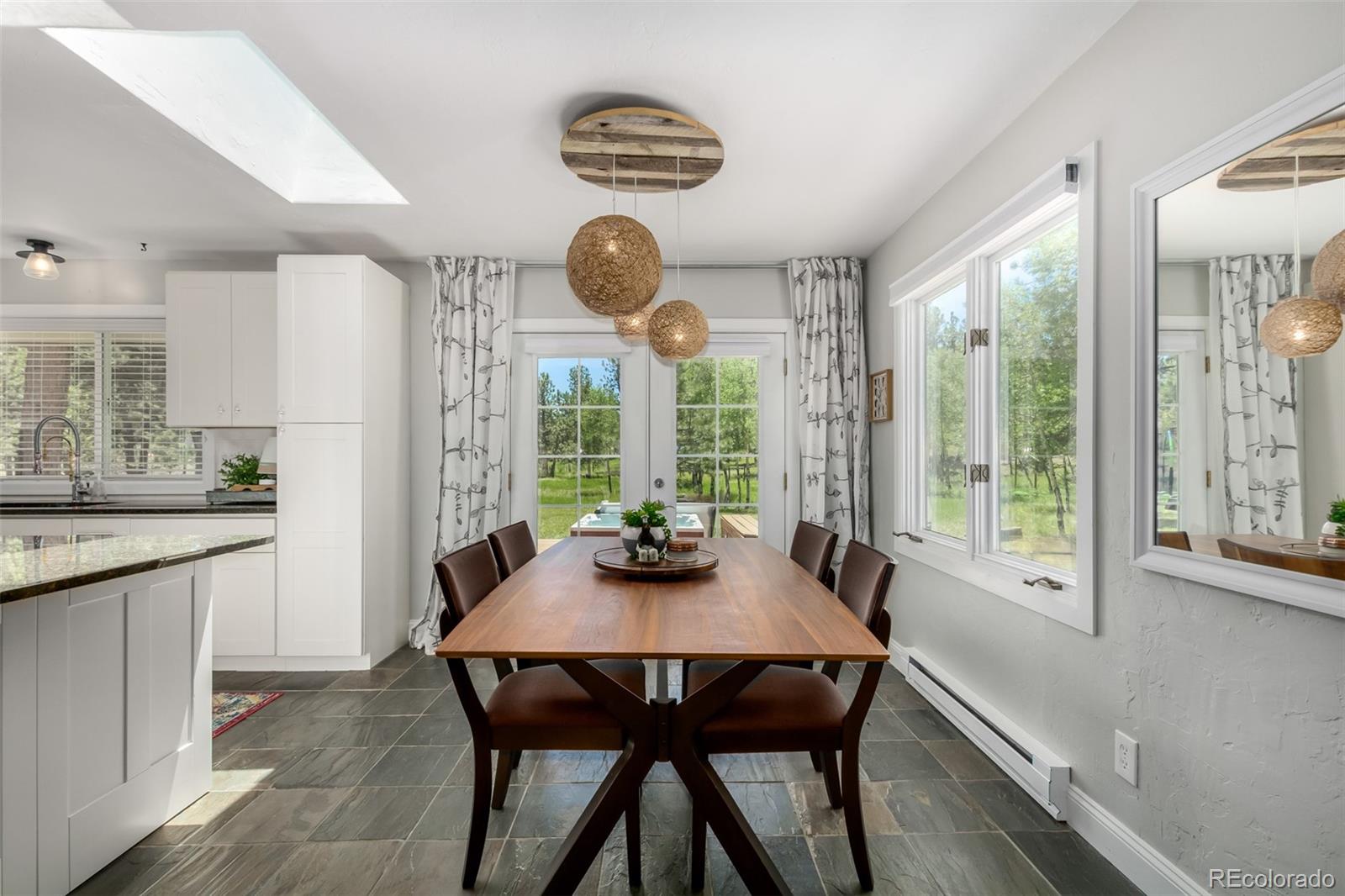 95 Double Tree Road Bailey, CO 80421 - Photo 5 of 40 a dining room with furniture a chandelier and wooden floor