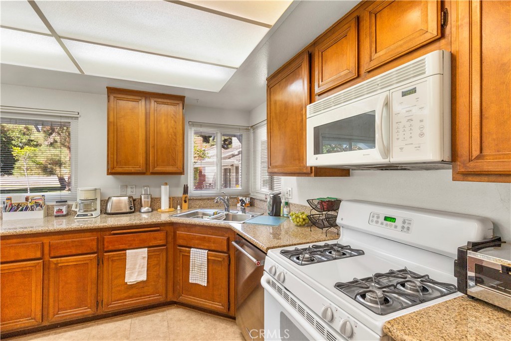 24142 Minnetonka Lane Lake Forest, CA 92630 - Photo 12 of 30 a kitchen with a sink stove top oven and microwave