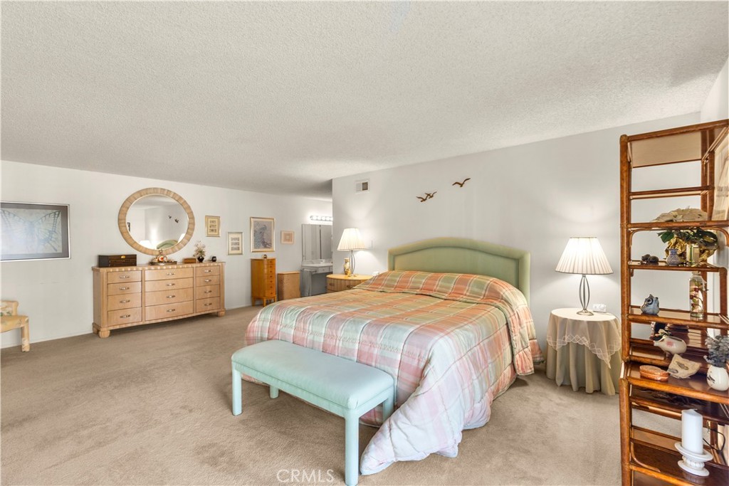 24142 Minnetonka Lane Lake Forest, CA 92630 - Photo 19 of 30 a bedroom with a bed a table and painting