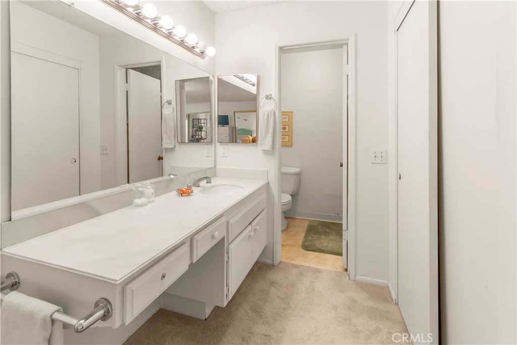24142 Minnetonka Lane Lake Forest, CA 92630 - Photo 20 of 30 a bathroom with a sink a mirror and a shower