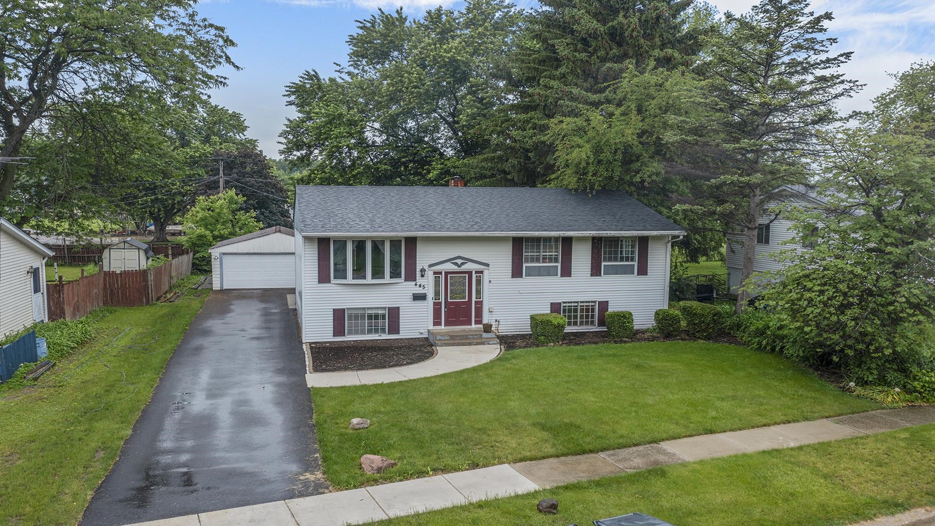 445 Rebecca Road Belvidere, IL 61008 - Photo 1 of 34 a front view of a house with a garden and trees