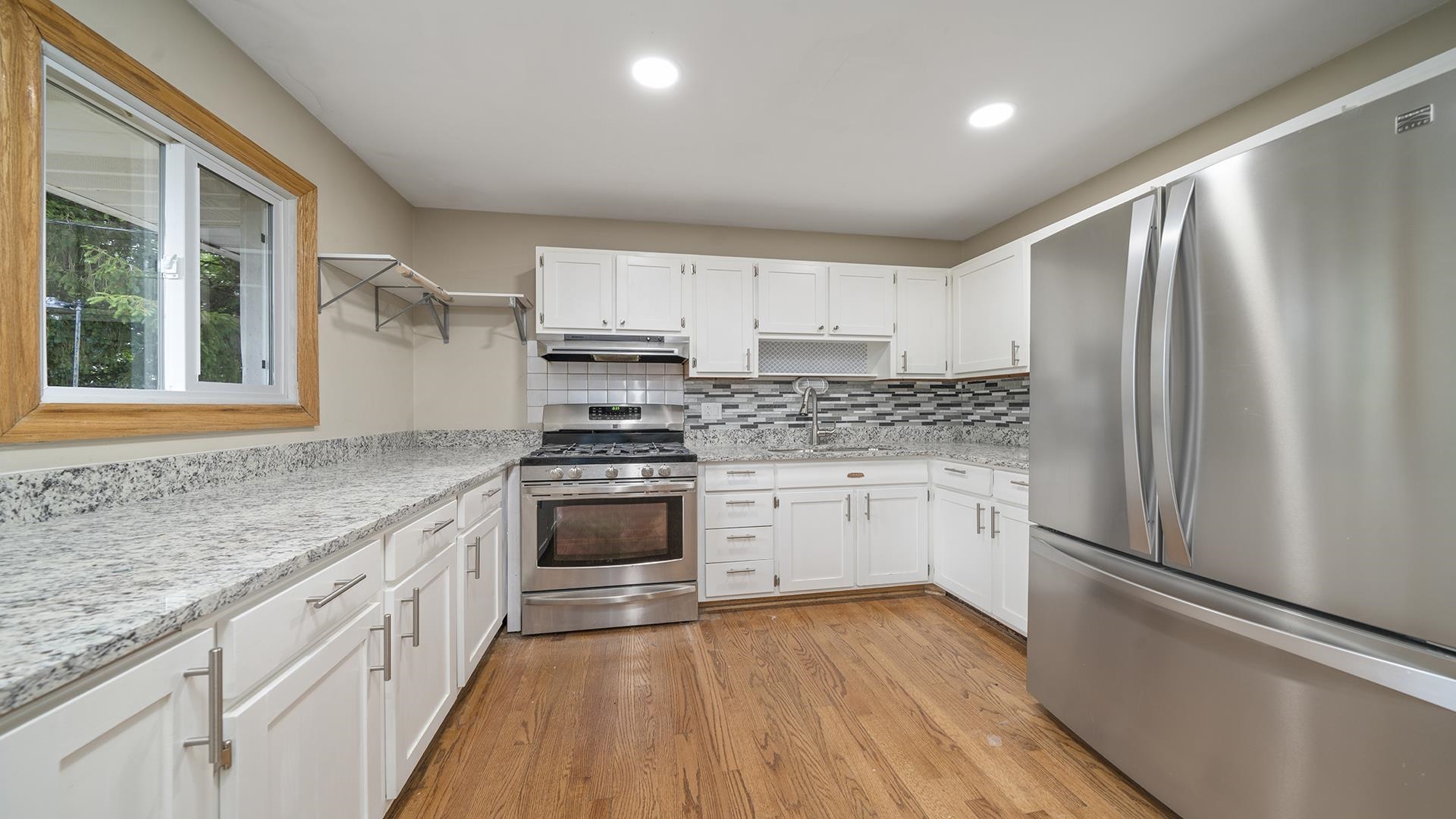 445 Rebecca Road Belvidere, IL 61008 - Photo 15 of 34 a kitchen with granite countertop stainless steel appliances a refrigerator sink and microwave