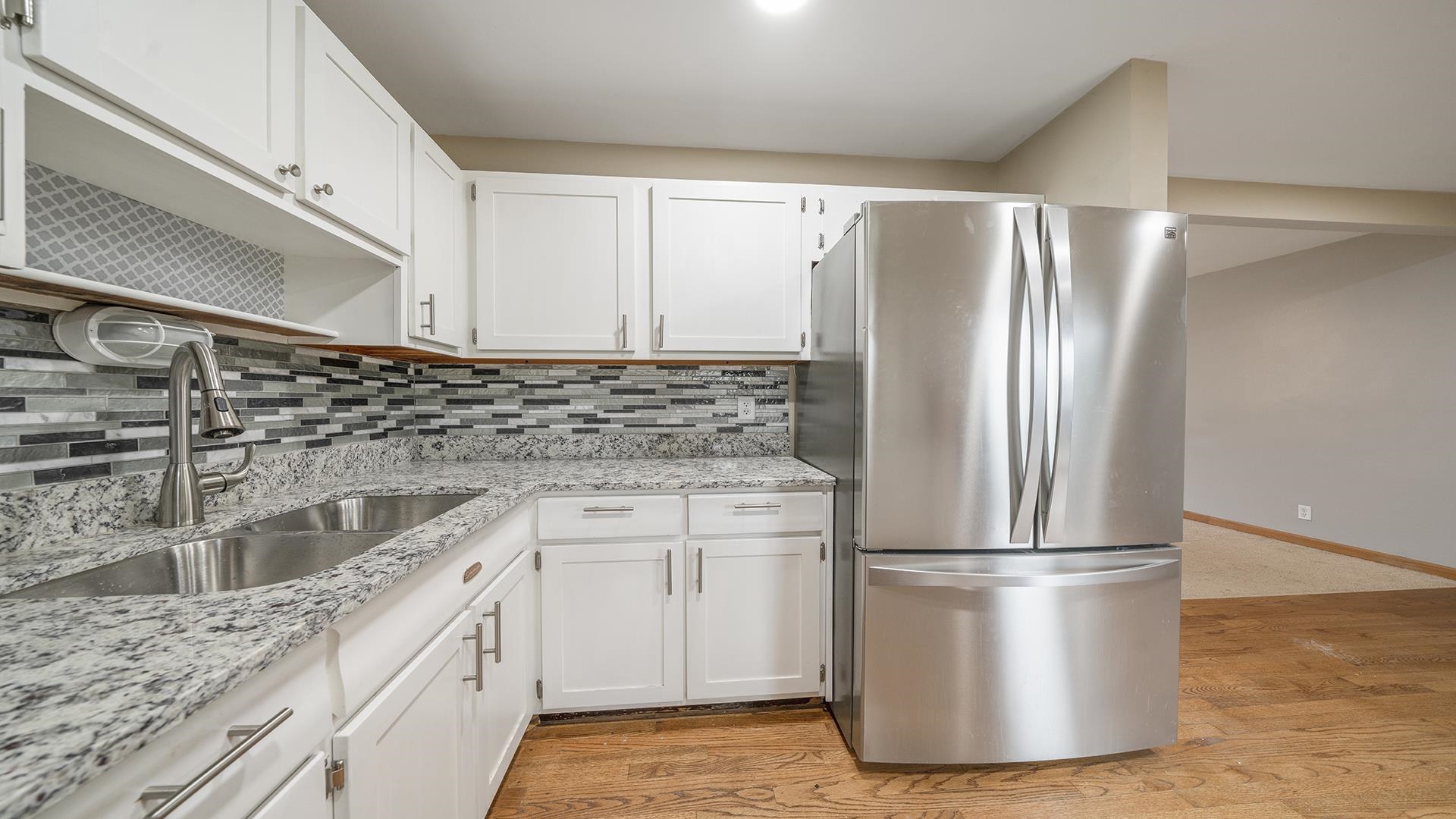 445 Rebecca Road Belvidere, IL 61008 - Photo 16 of 34 a kitchen with a refrigerator sink and white cabinets