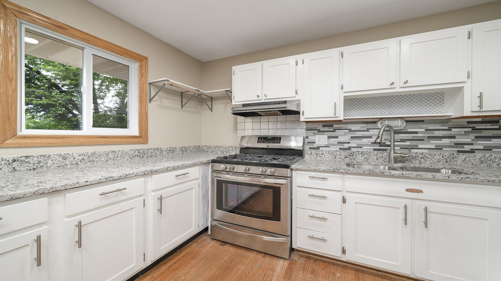 445 Rebecca Road Belvidere, IL 61008 - Photo 17 of 34 a kitchen with granite countertop white cabinets and white appliances
