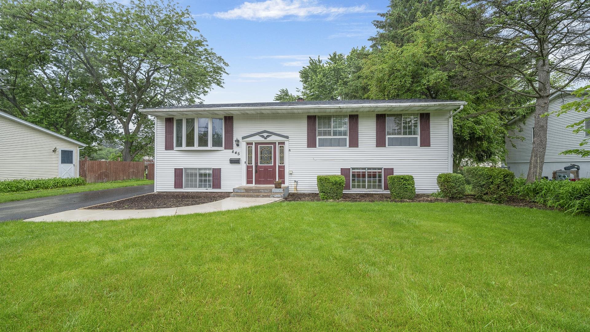 445 Rebecca Road Belvidere, IL 61008 - Photo 2 of 34 a front view of house with yard and trees