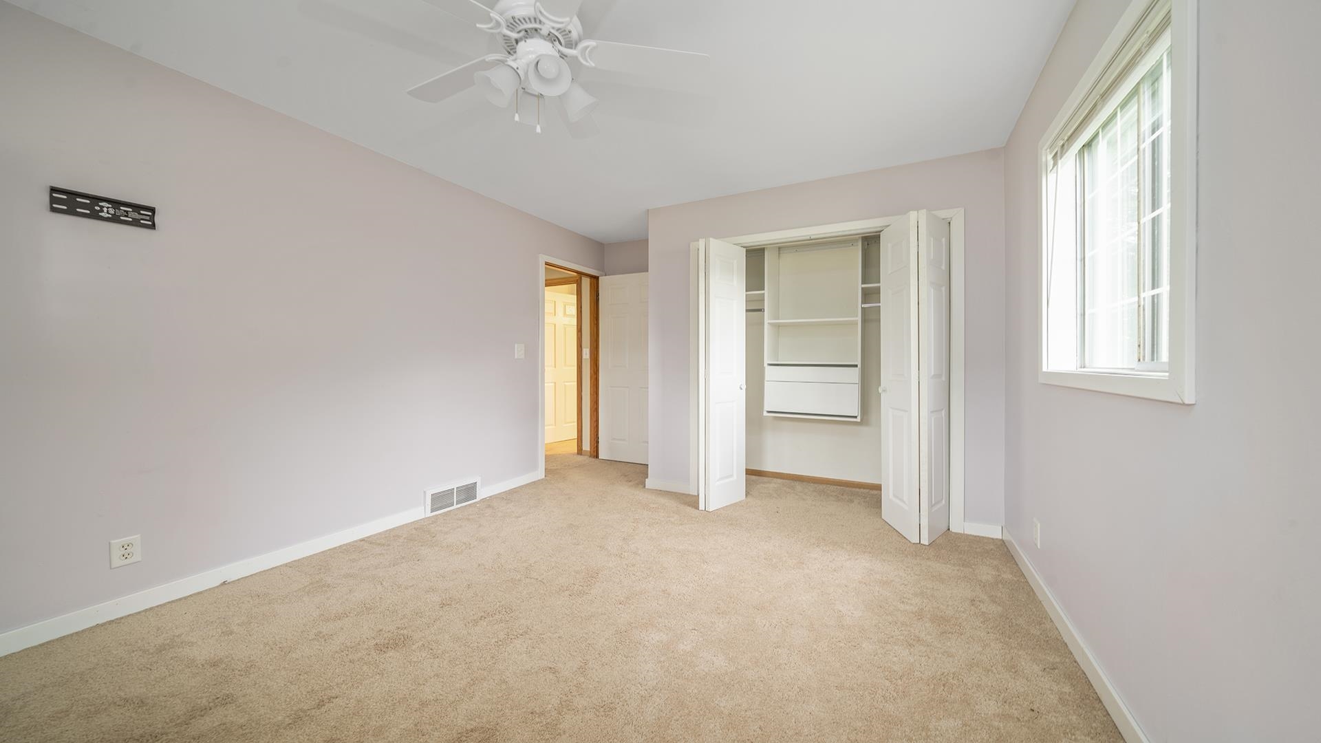 445 Rebecca Road Belvidere, IL 61008 - Photo 4 of 34 an empty room with windows and closet