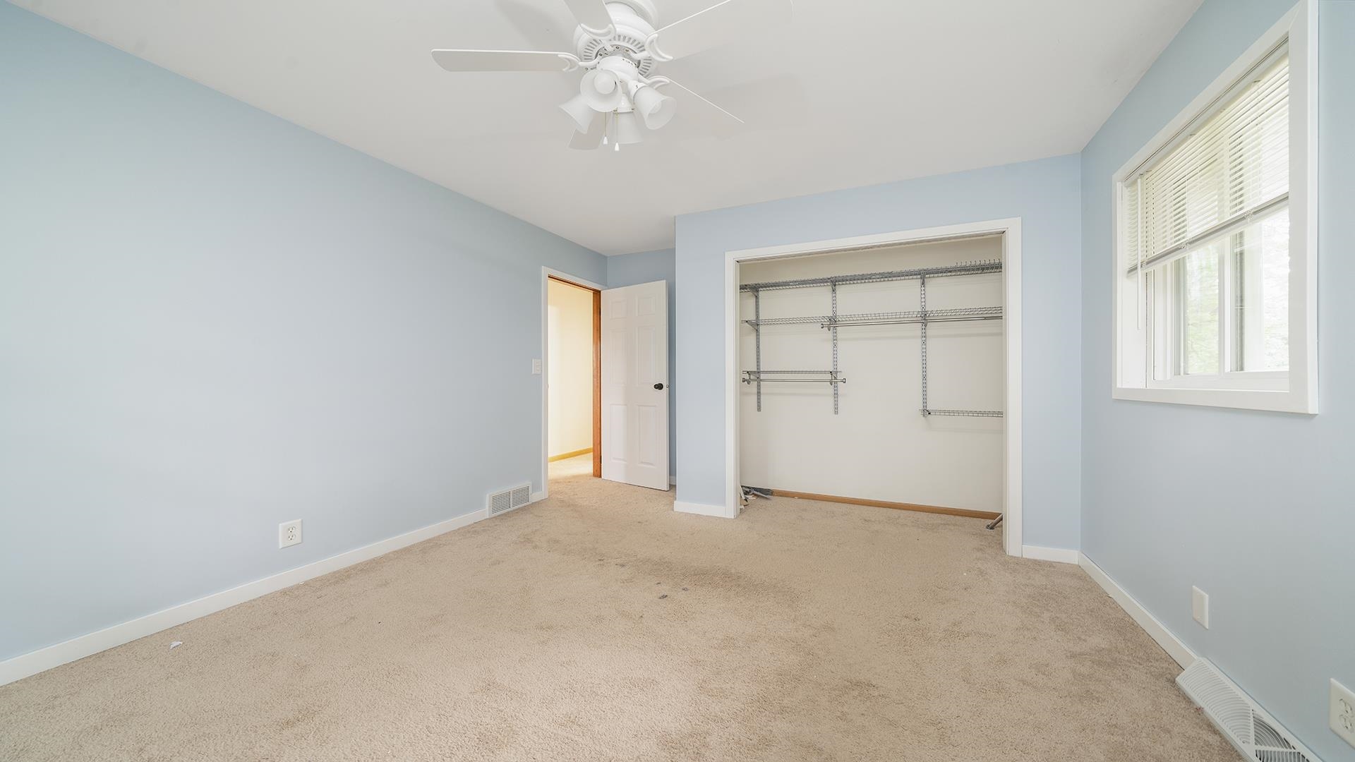 445 Rebecca Road Belvidere, IL 61008 - Photo 6 of 34 an empty room with windows and closet