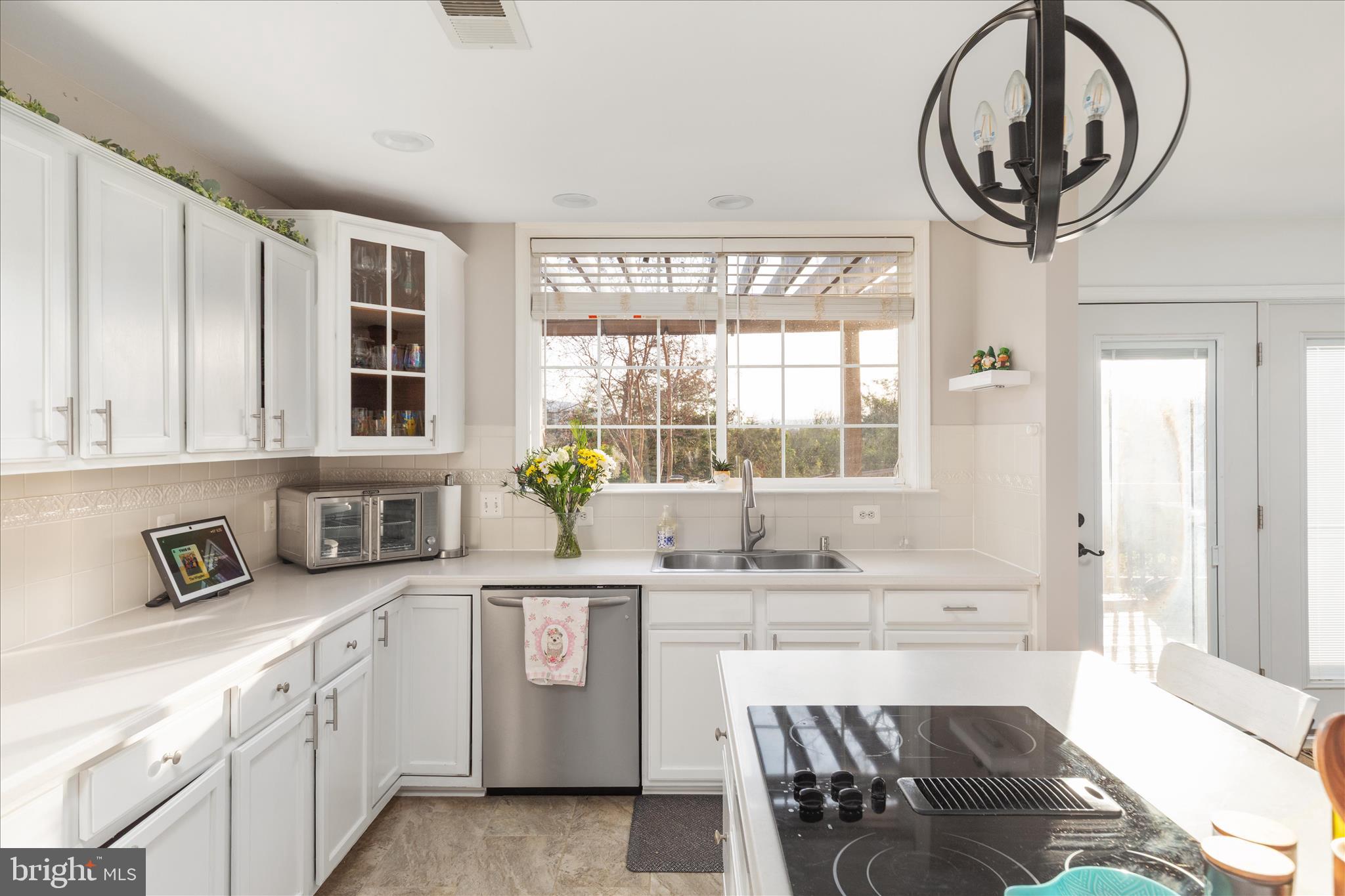 1161 Happy Ridge Drive Front Royal, VA 22630 - Photo 14 of 49 a kitchen with stainless steel appliances granite countertop a sink and a stove next to a window