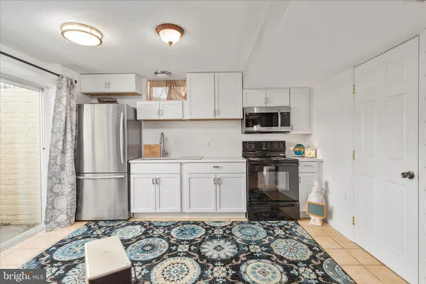 a kitchen with stainless steel appliances granite countertop a refrigerator stove and sink