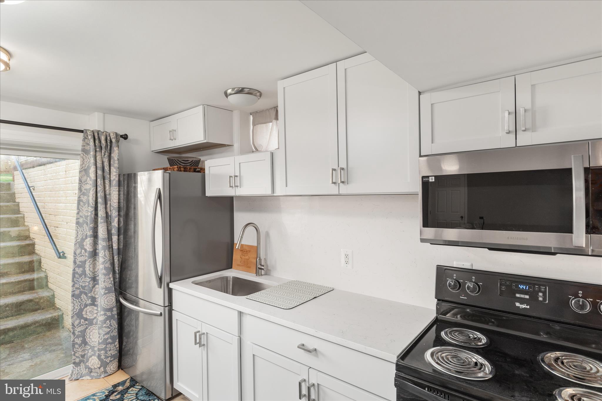 1161 Happy Ridge Drive Front Royal, VA 22630 - Photo 35 of 49 a kitchen with stainless steel appliances a stove a refrigerator and cabinets