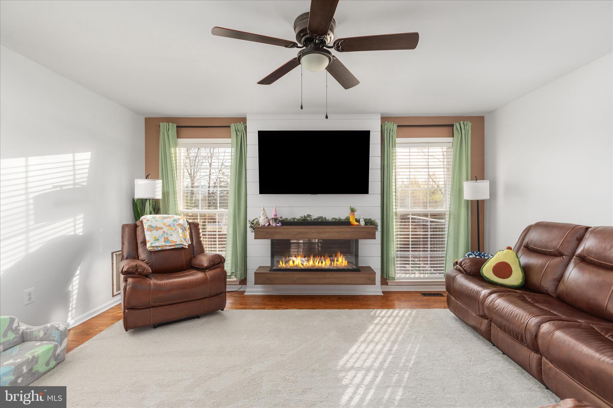 1161 Happy Ridge Drive Front Royal, VA 22630 - Photo 9 of 49 a living room with furniture a flat screen tv and a fireplace