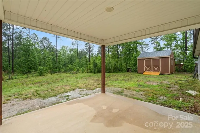 a backyard of a house with lots of green space and fountain