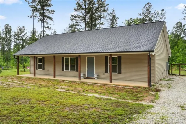 a house that has a tree in front of it