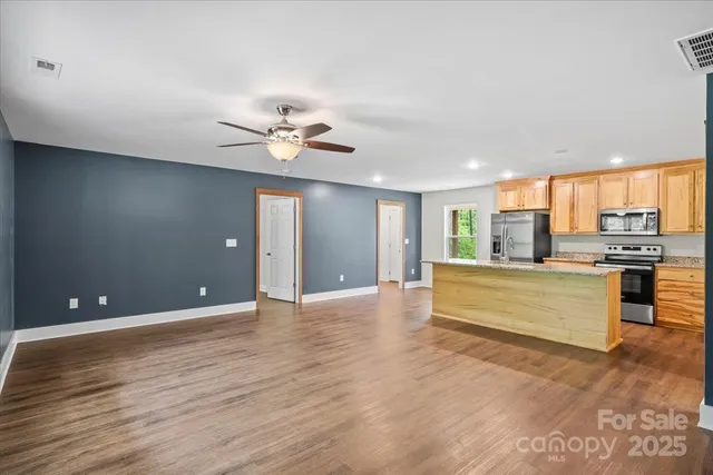 a view of kitchen with refrigerator and window