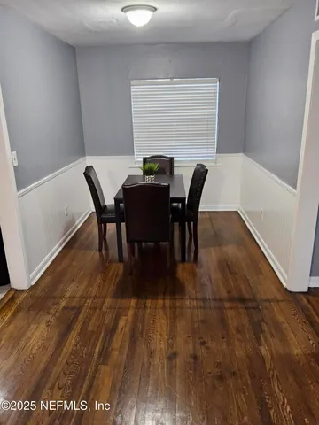 a view of a dining room with furniture and wooden floor