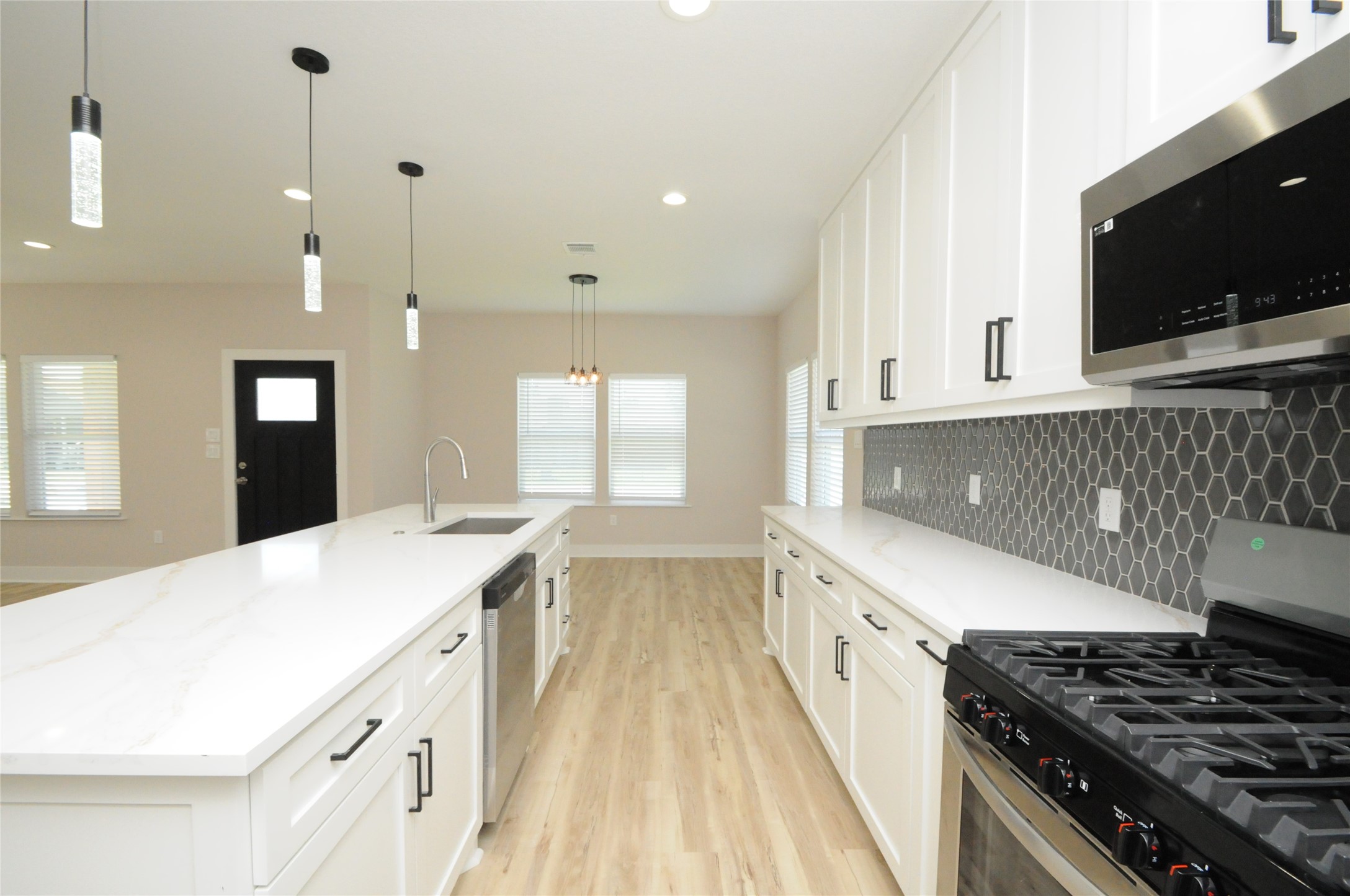 8203 Gladstone Street Houston, TX 77051 - Photo 14 of 41 a kitchen with granite countertop a sink stove and cabinets