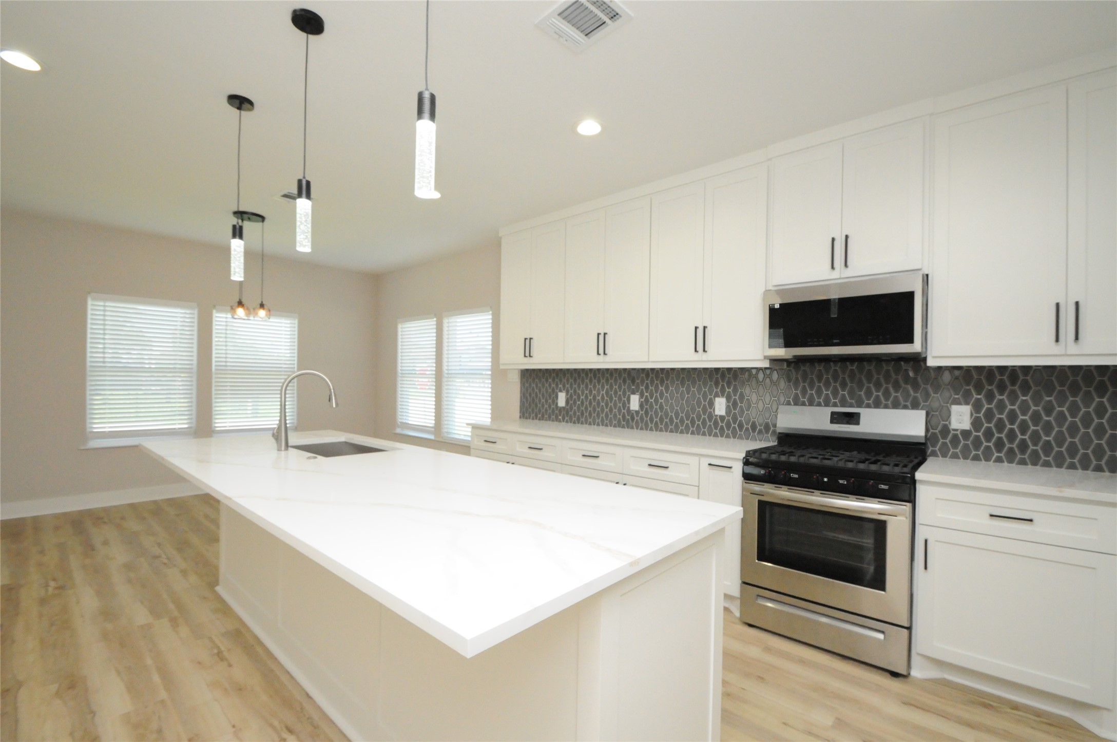 8203 Gladstone Street Houston, TX 77051 - Photo 15 of 41 a kitchen with a stove and a kitchen island