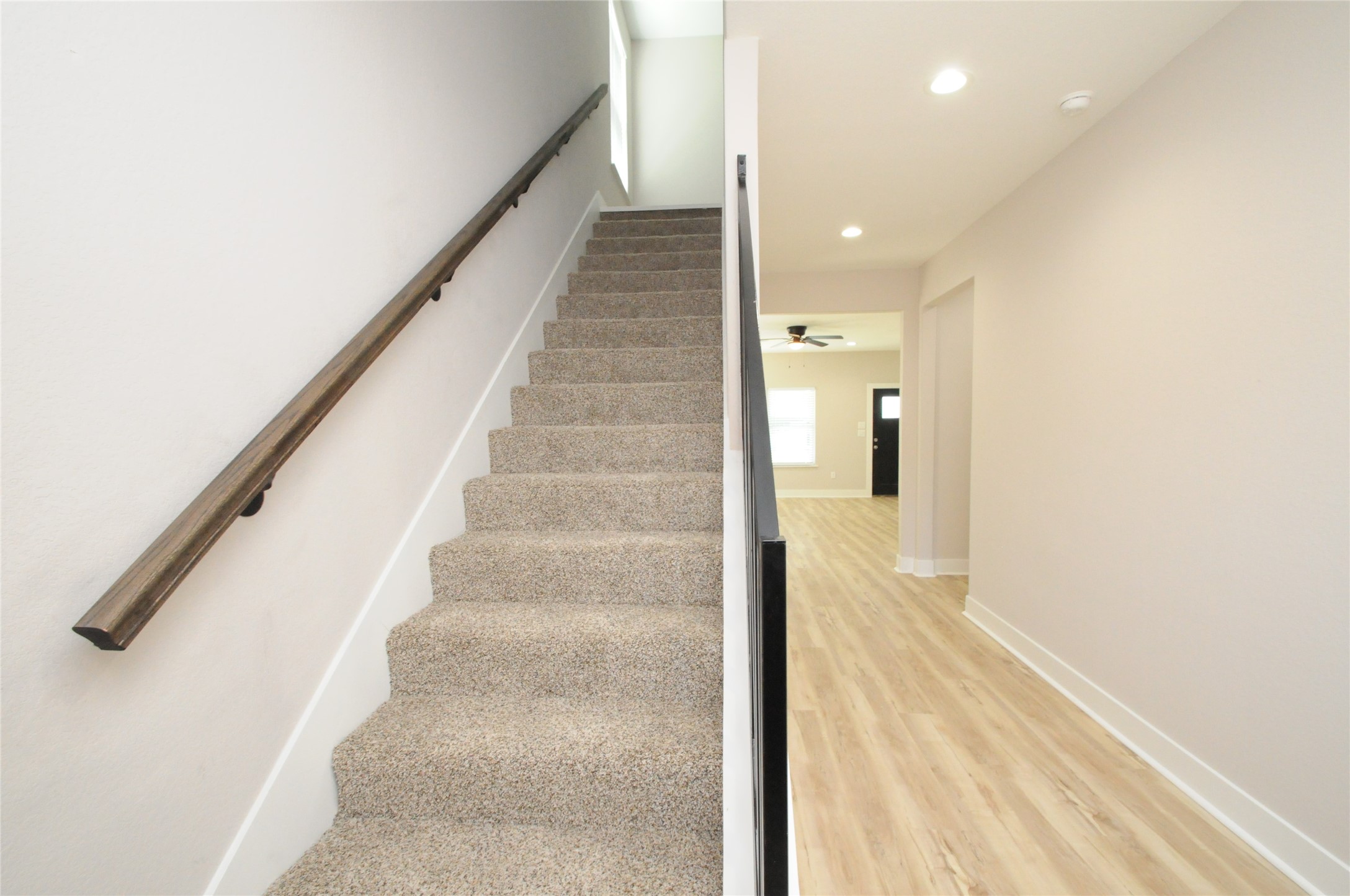 8203 Gladstone Street Houston, TX 77051 - Photo 17 of 41 a view of a hallway with wooden floor and staircase