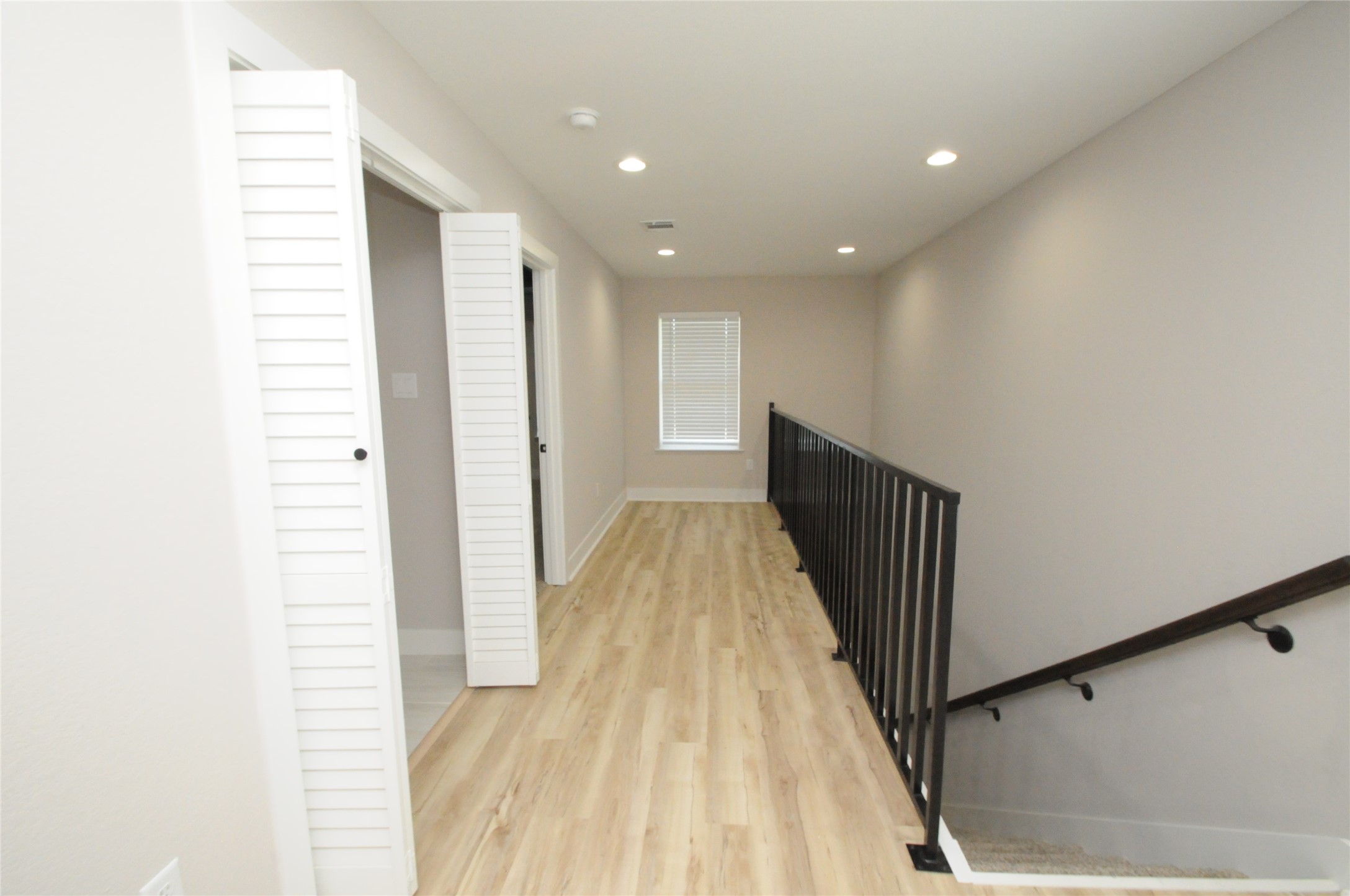 8203 Gladstone Street Houston, TX 77051 - Photo 18 of 41 a view of a hallway with wooden floor