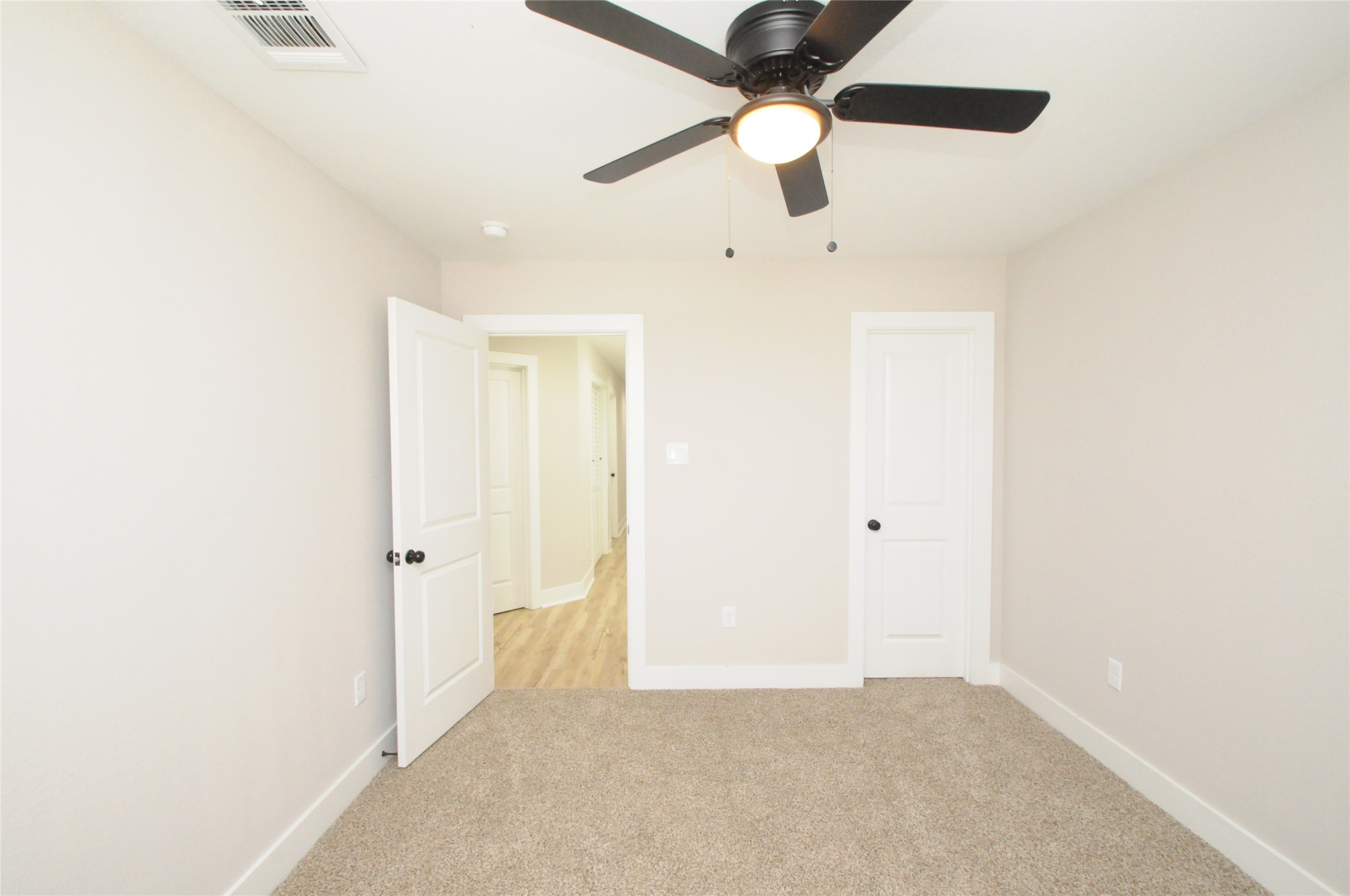 8203 Gladstone Street Houston, TX 77051 - Photo 32 of 41 an empty room with a ceiling fan and a window