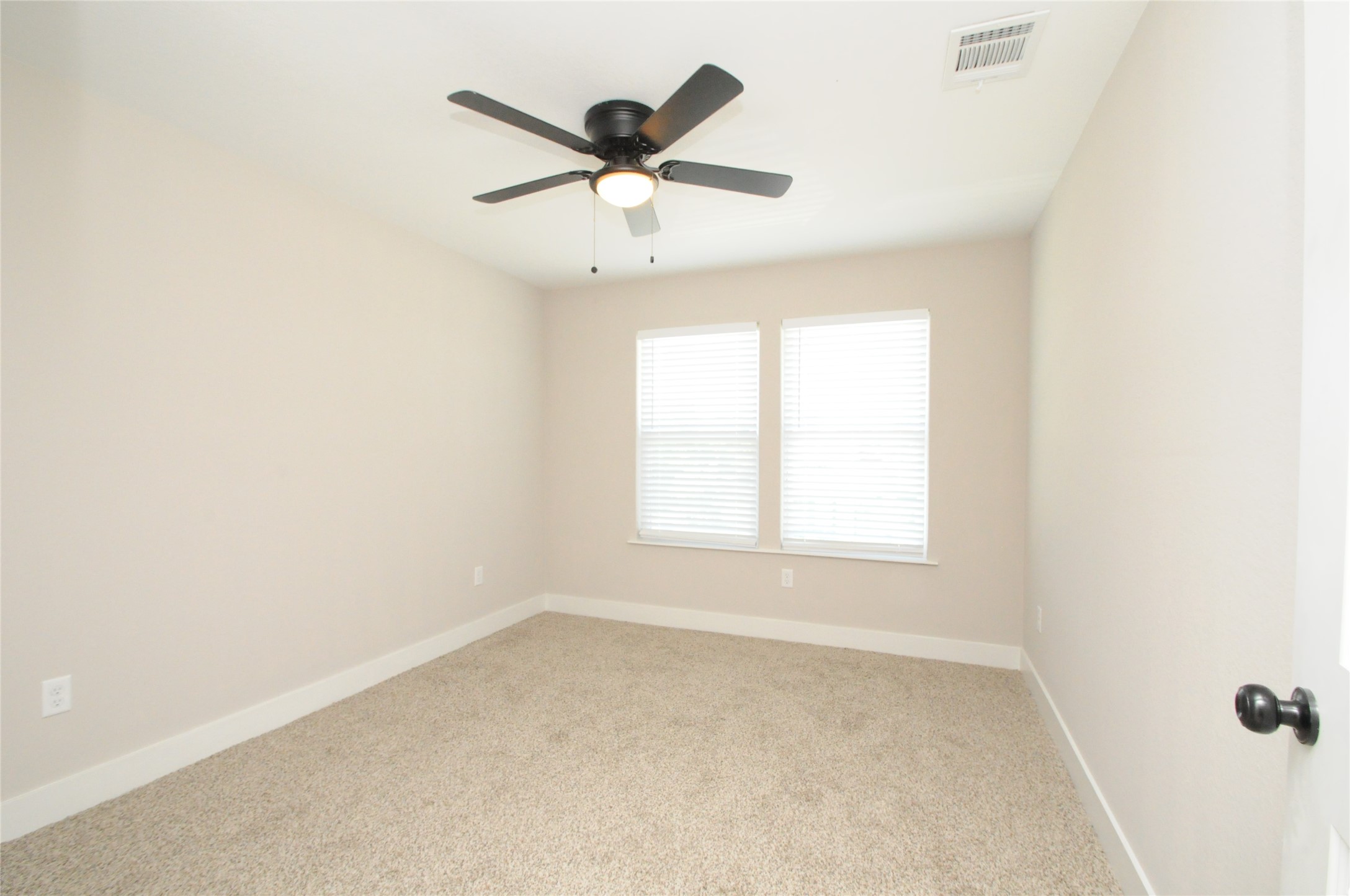 8203 Gladstone Street Houston, TX 77051 - Photo 34 of 41 an empty room with a window and a fan