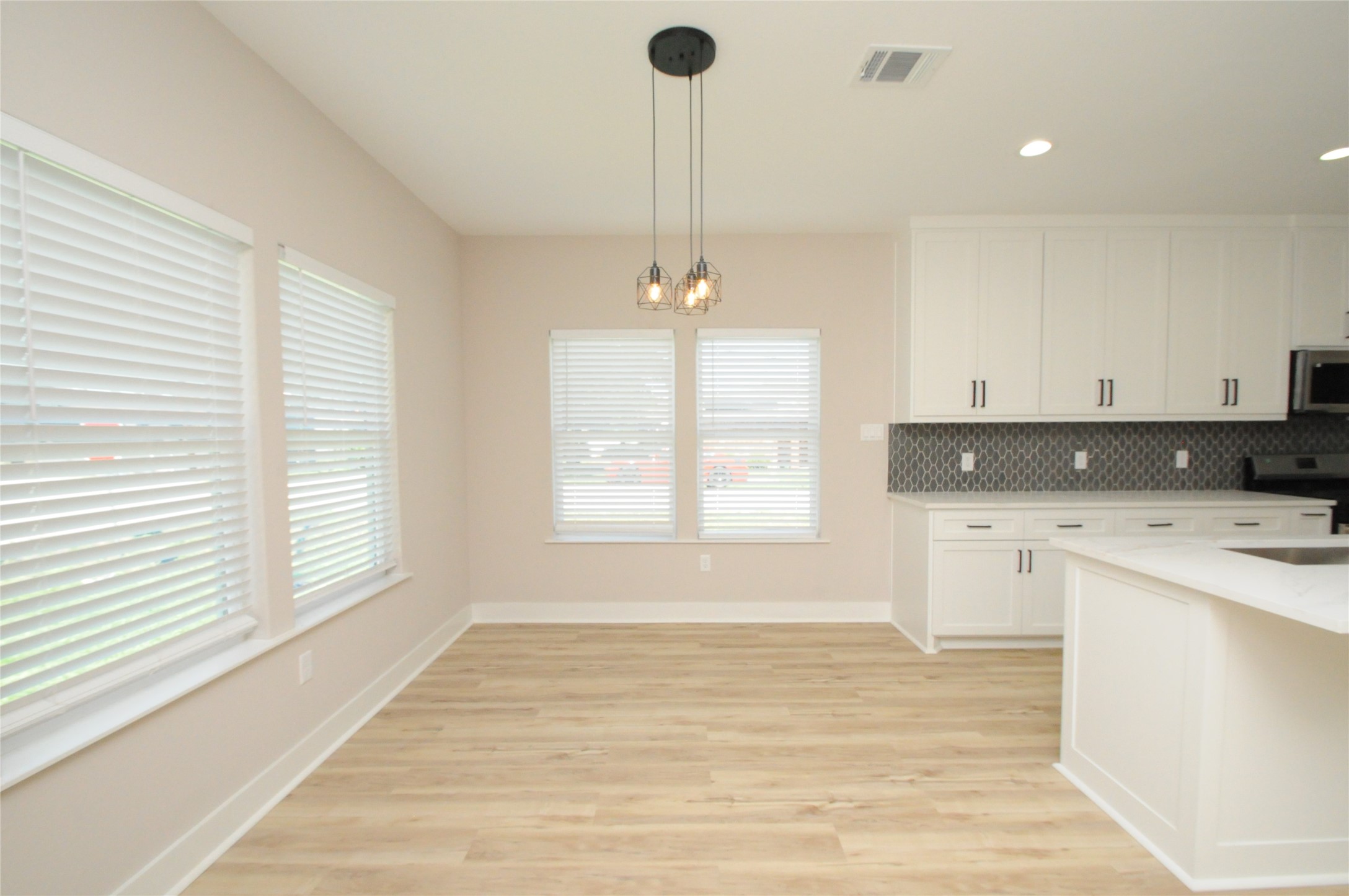 8203 Gladstone Street Houston, TX 77051 - Photo 6 of 41 a view of a kitchen with a stove cabinets and a wooden floor