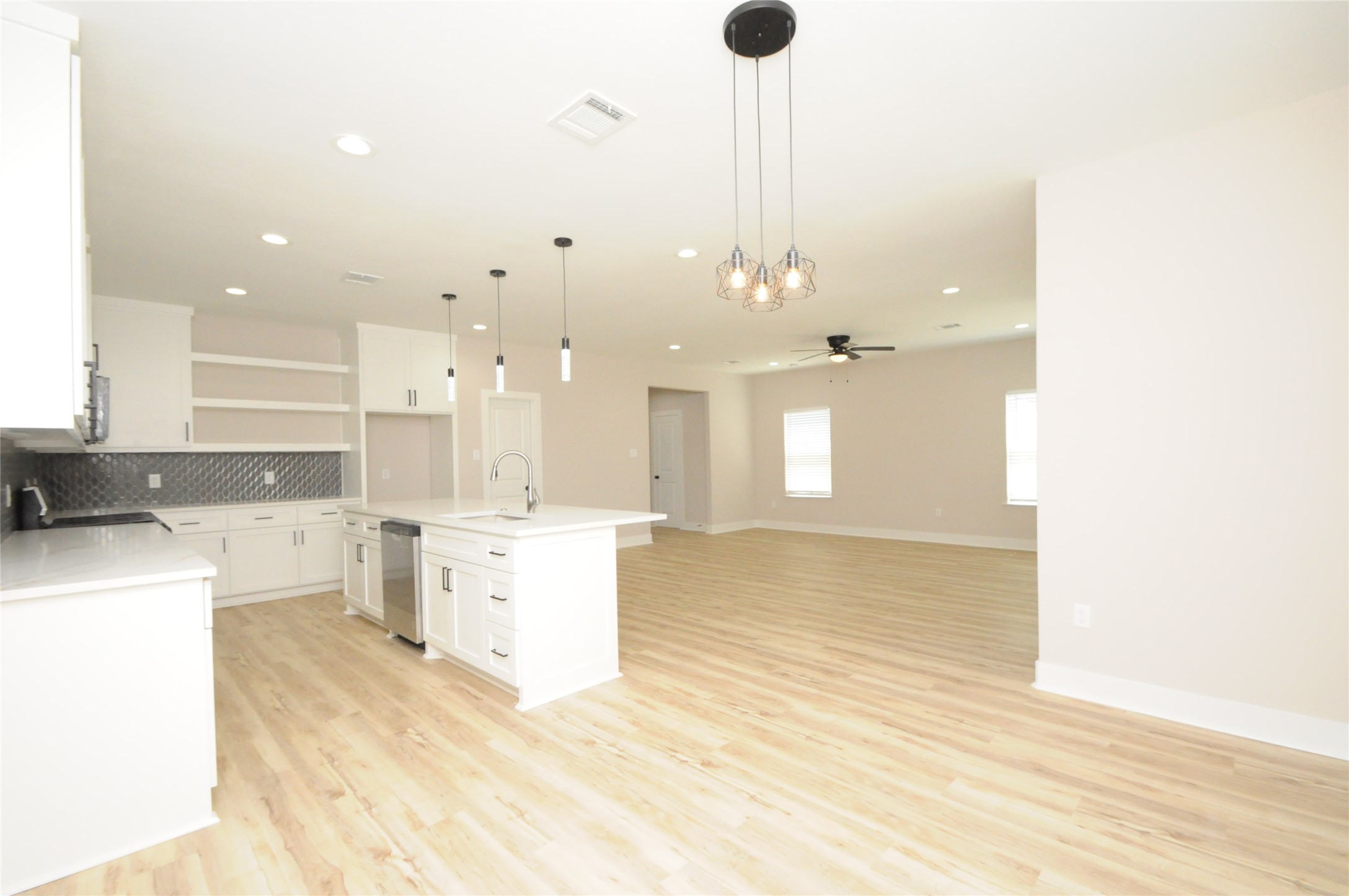 8203 Gladstone Street Houston, TX 77051 - Photo 9 of 41 a large kitchen with a lot of cabinets and a wooden floor