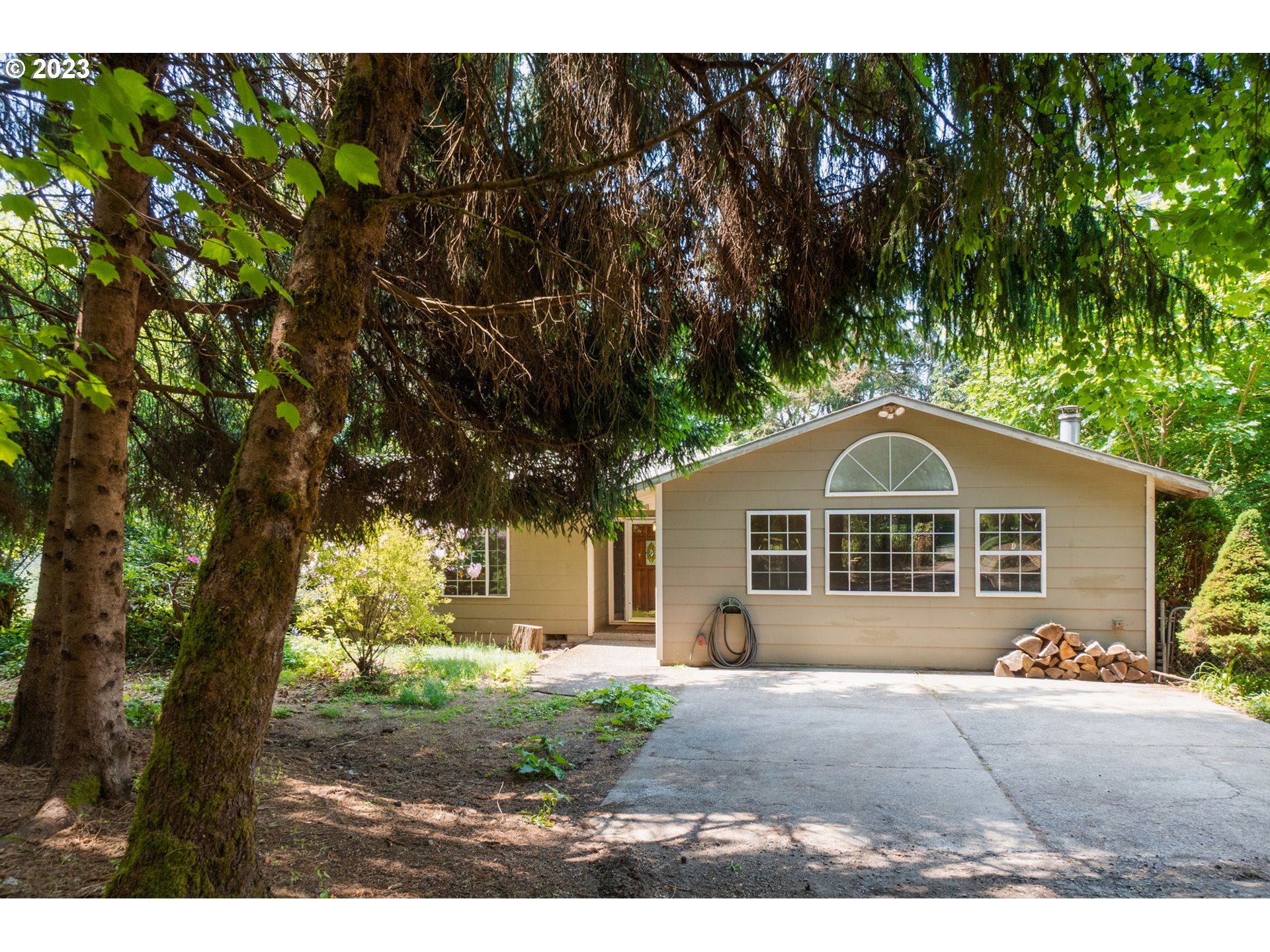 a front view of a house with a garden and yard