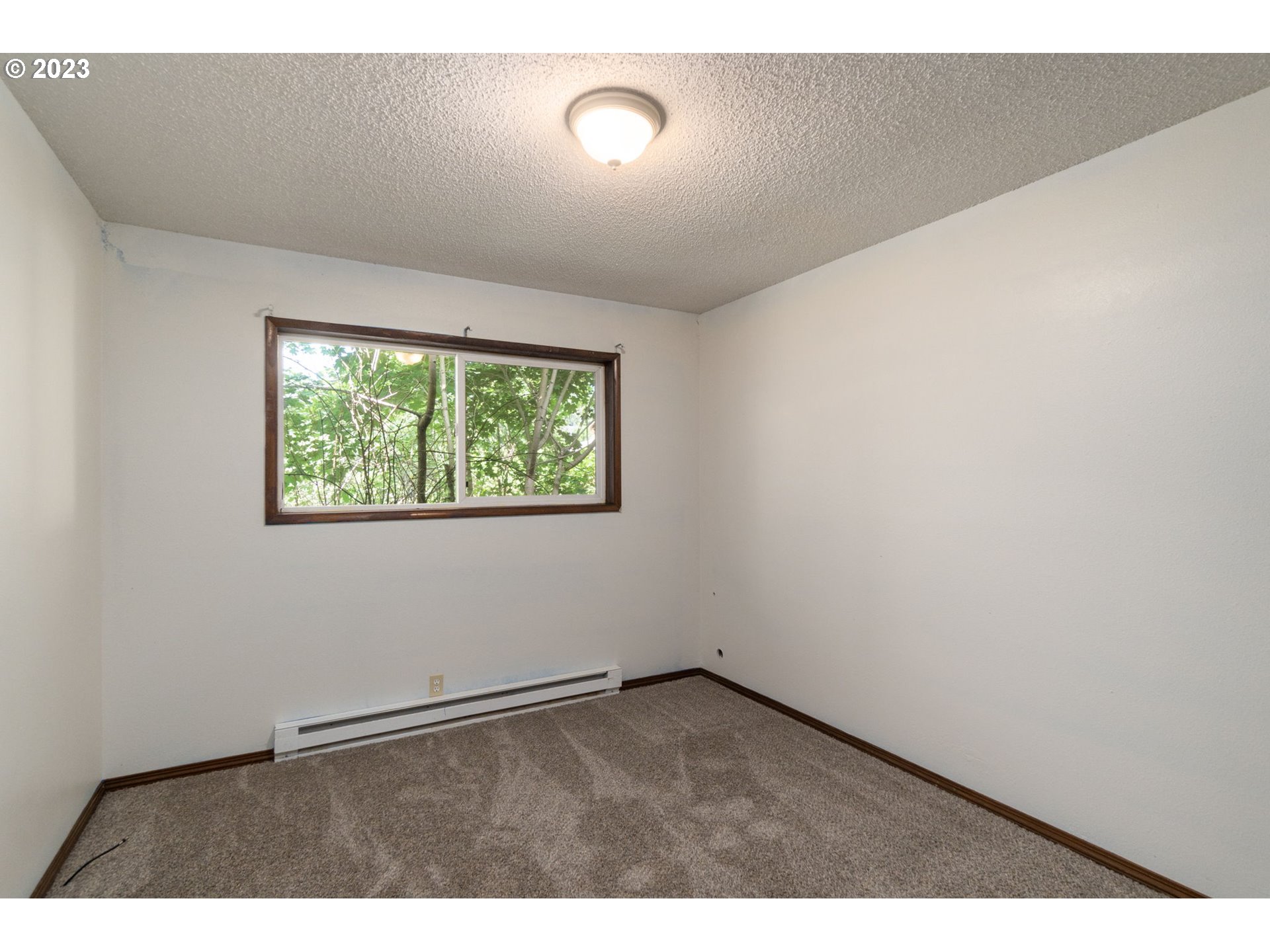 745 Southeast Littlepage Road Corbett, OR 97019 - Photo 19 of 39 an empty room with wooden floor and windows