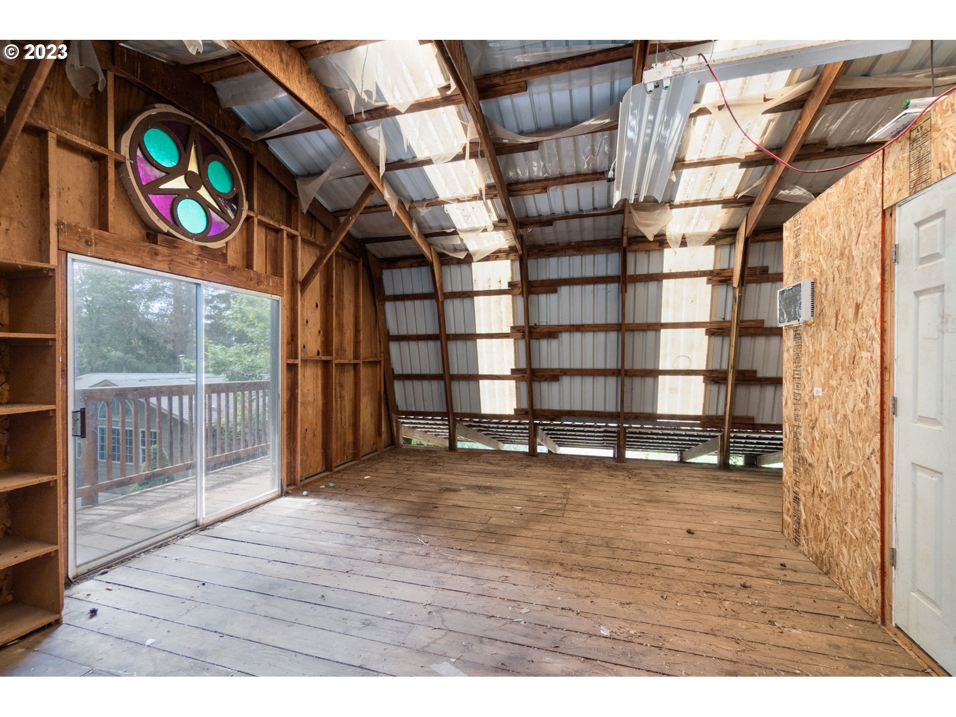 745 Southeast Littlepage Road Corbett, OR 97019 - Photo 29 of 39 a view of an empty room with wooden floor and windows