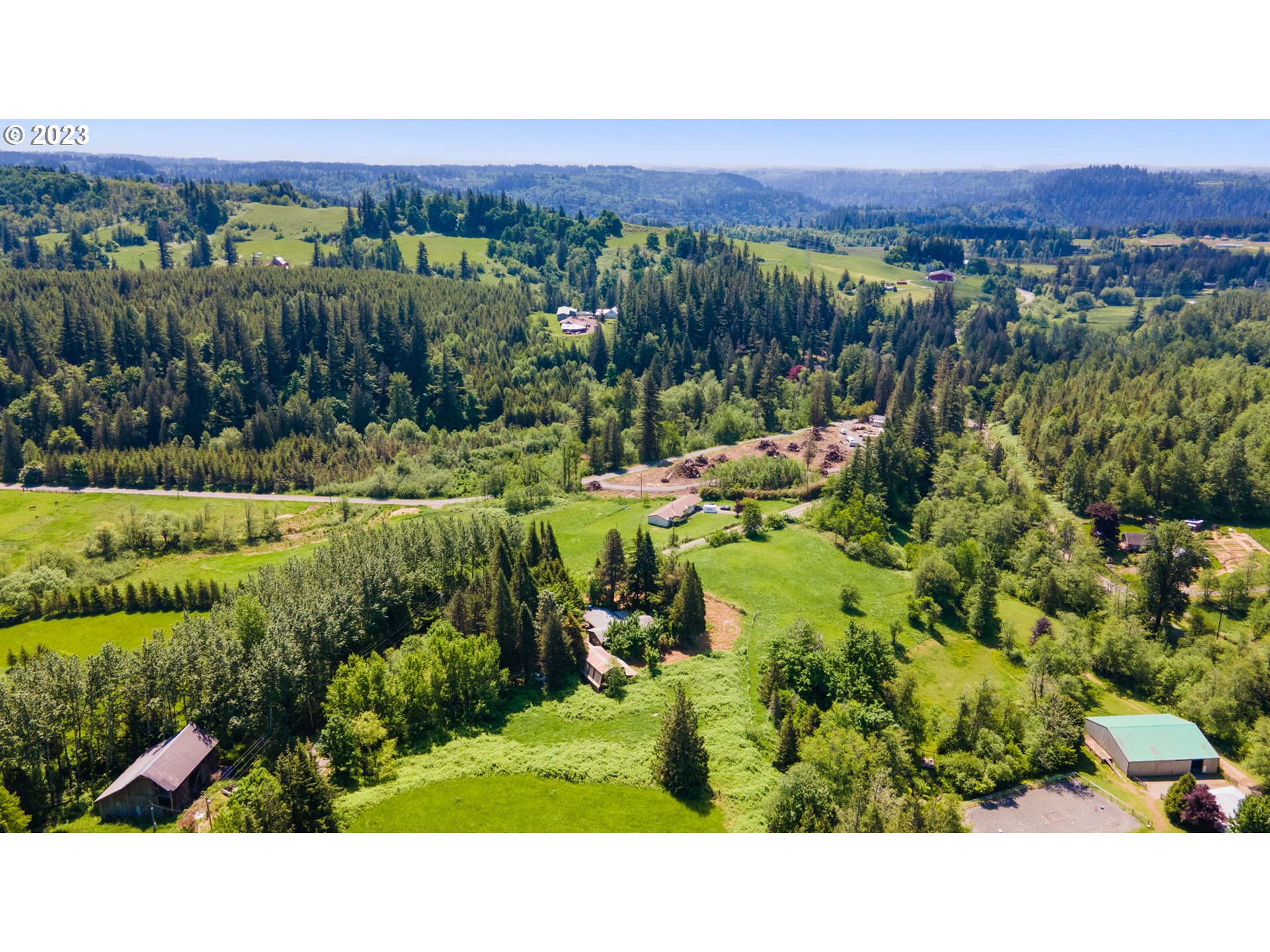 745 Southeast Littlepage Road Corbett, OR 97019 - Photo 34 of 39 a view of a lush green field with lots of plants and trees in the background