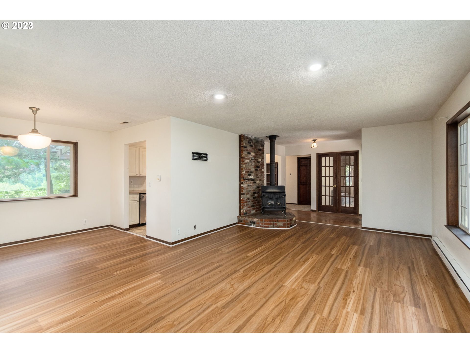 745 Southeast Littlepage Road Corbett, OR 97019 - Photo 5 of 39 an empty room with wooden floor and windows