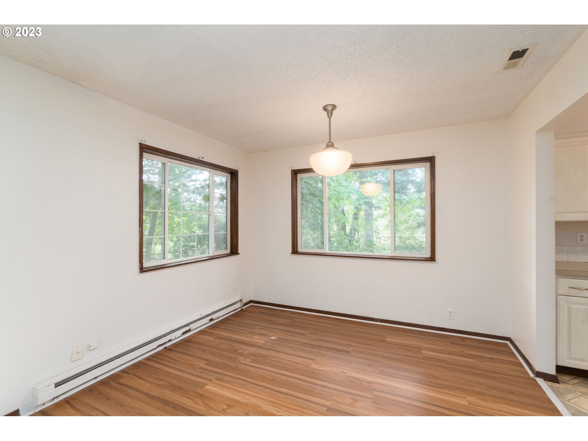 745 Southeast Littlepage Road Corbett, OR 97019 - Photo 6 of 39 an empty room with wooden floor and windows