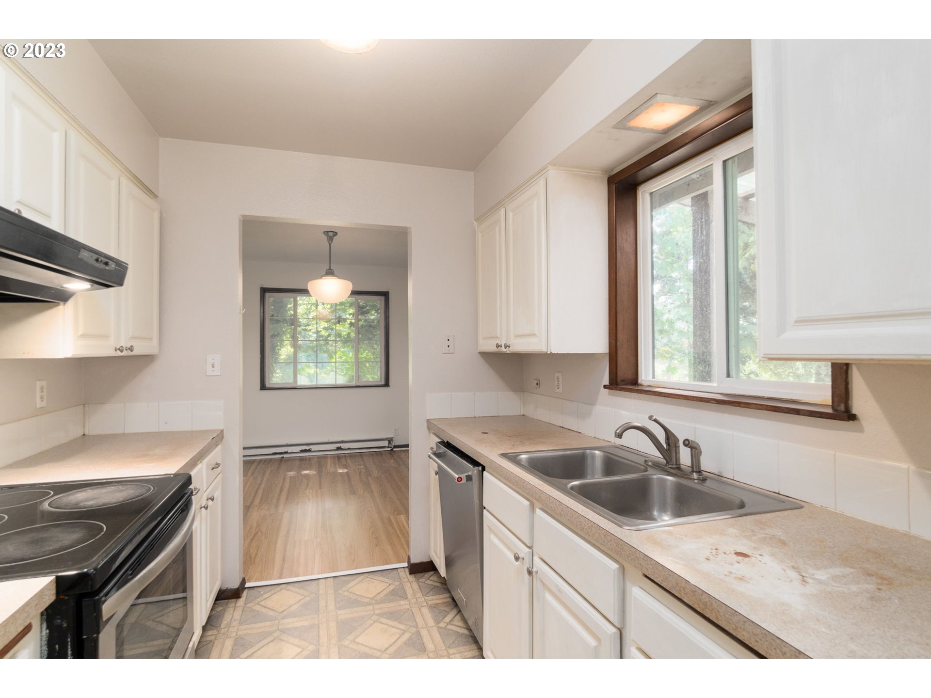 745 Southeast Littlepage Road Corbett, OR 97019 - Photo 9 of 39 a kitchen with a sink a stove cabinets and a window