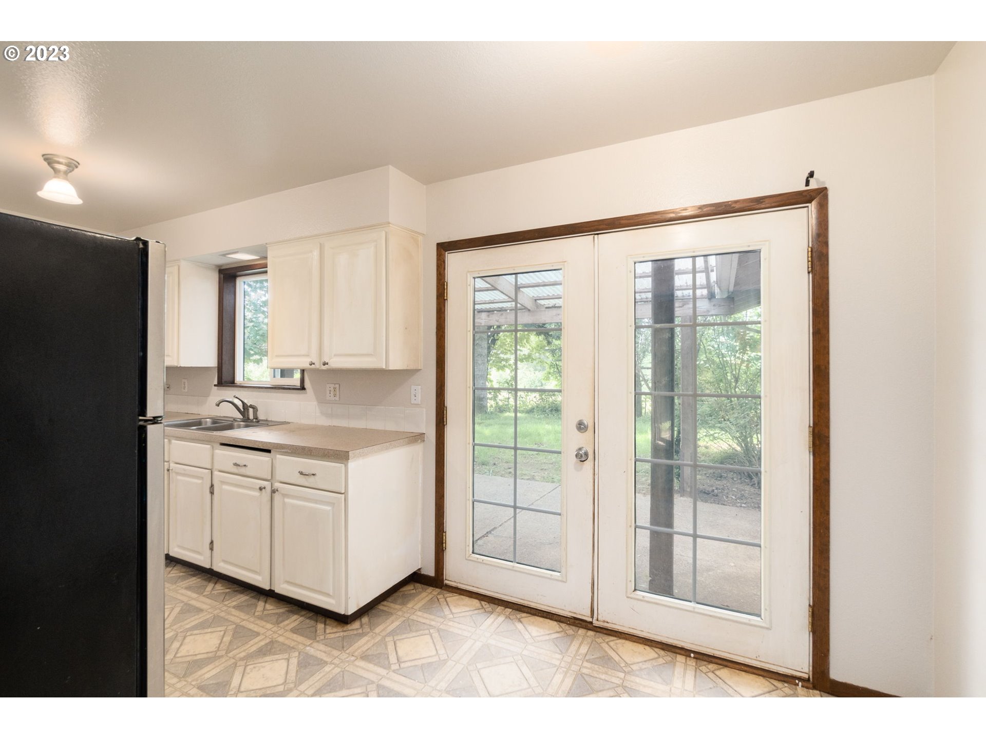 745 Southeast Littlepage Road Corbett, OR 97019 - Photo 10 of 39 a kitchen with stainless steel appliances granite countertop a stove a sink and white cabinets with wooden floors