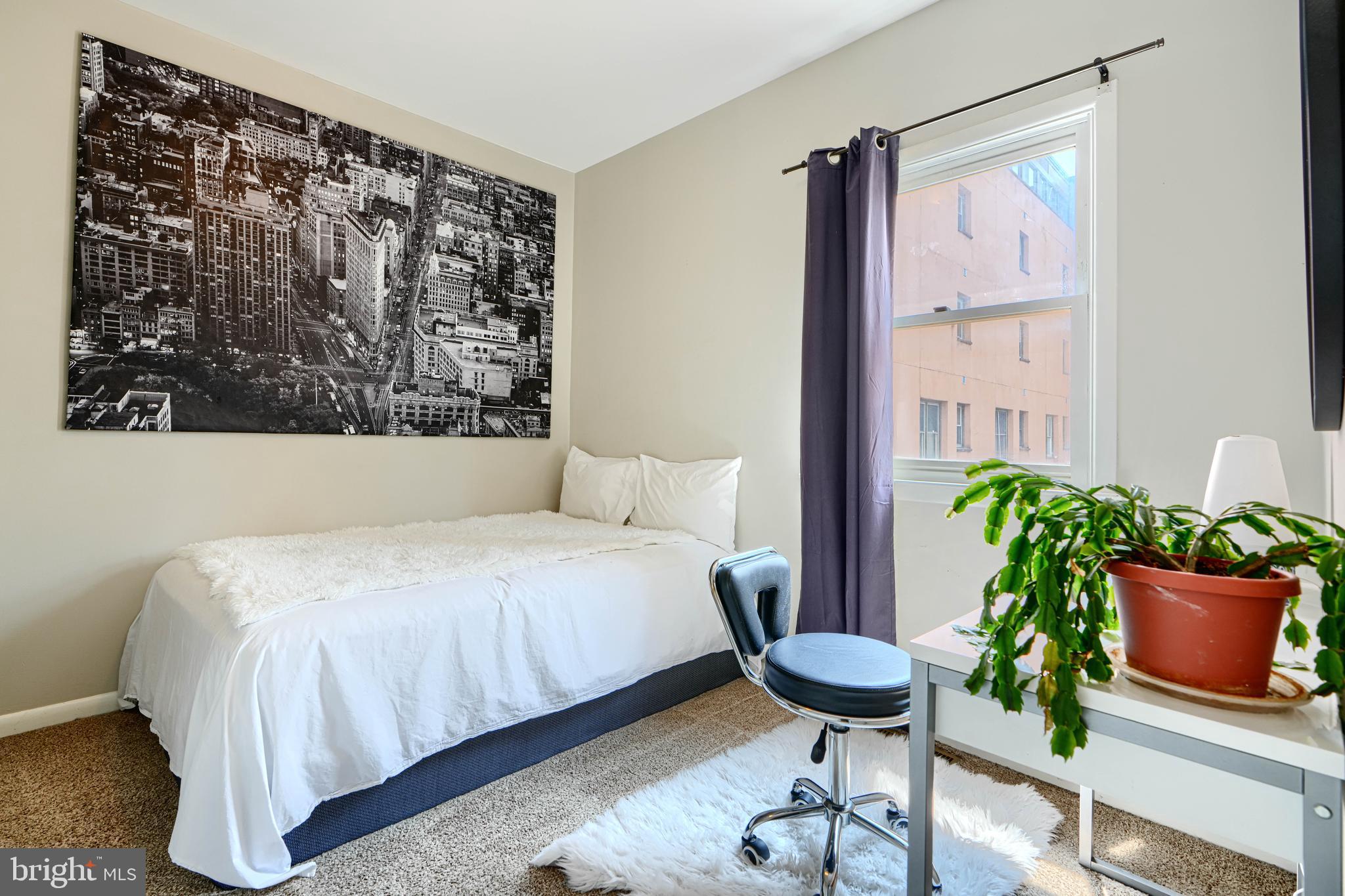 123 West Barre Street, Unit 103 Baltimore, MD 21201 - Photo 12 of 26 a bed sitting in a room next to a window