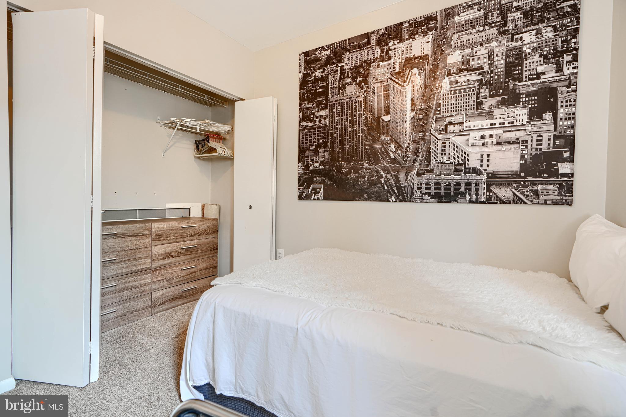 123 West Barre Street, Unit 103 Baltimore, MD 21201 - Photo 14 of 26 a bedroom with a bed and a wall painting