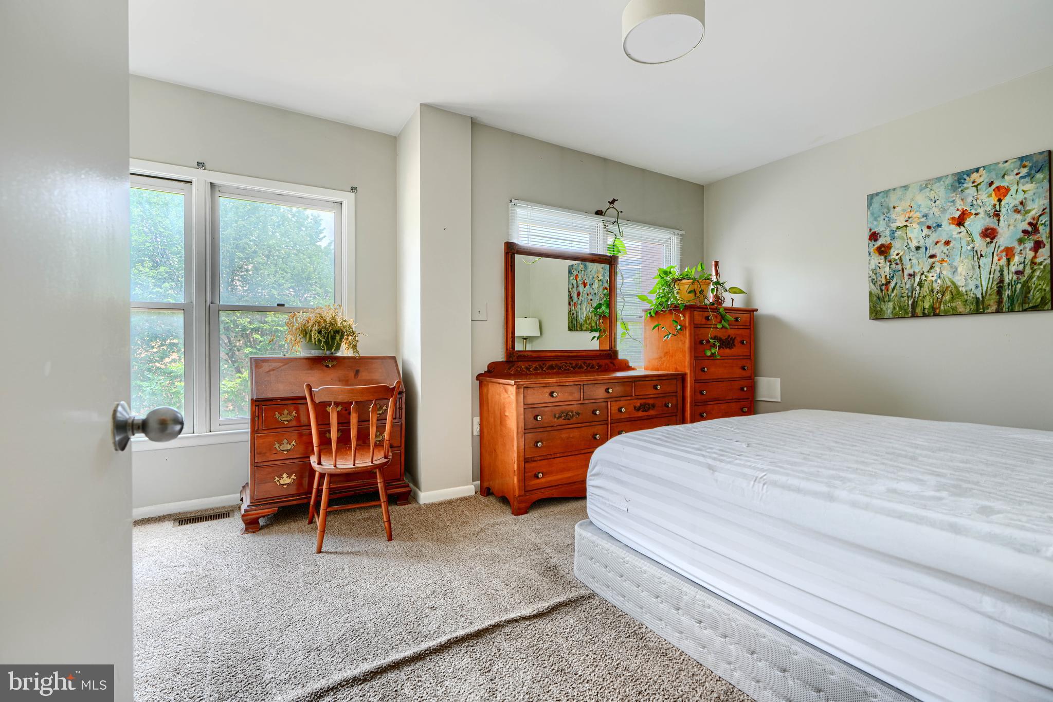 123 West Barre Street, Unit 103 Baltimore, MD 21201 - Photo 15 of 26 a bedroom with a bed and large windows