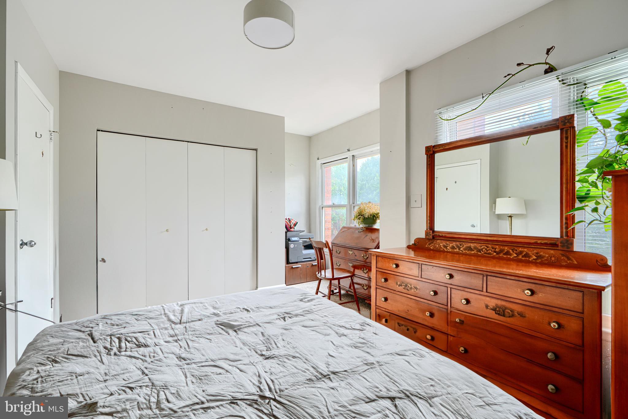 123 West Barre Street, Unit 103 Baltimore, MD 21201 - Photo 18 of 26 a bedroom with a bed and wooden floor