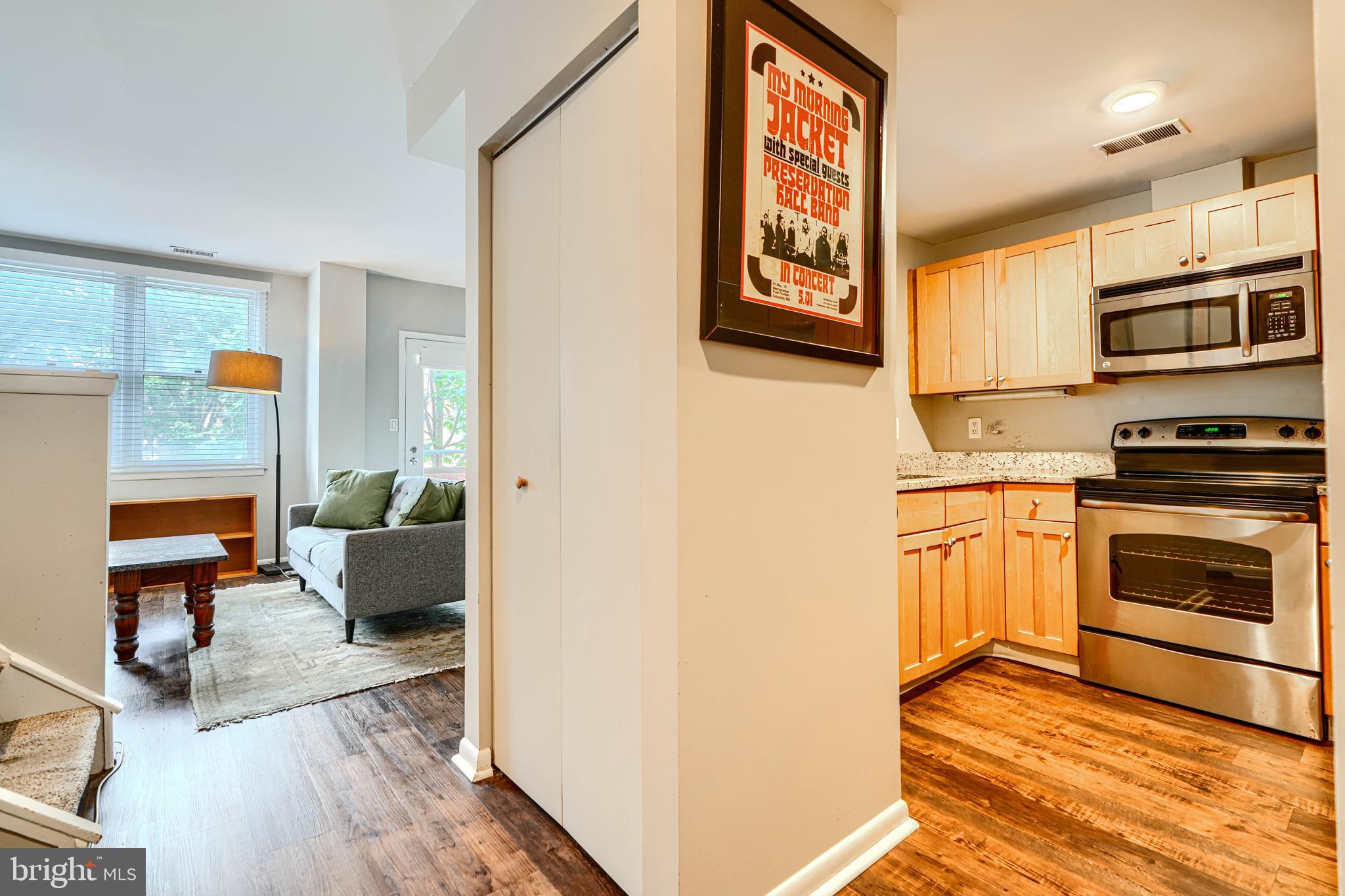 123 West Barre Street, Unit 103 Baltimore, MD 21201 - Photo 2 of 26 a kitchen with stainless steel appliances a stove top oven a sink and a refrigerator